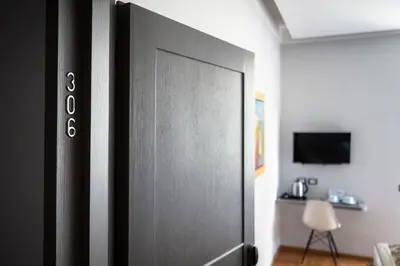 a sliding door in a room with a tv at Mascherino Suites in Rome