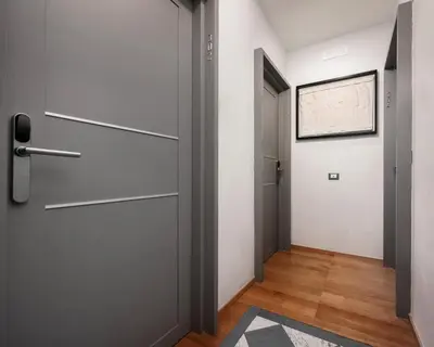 a hallway with a door and a rug at Mascherino Suites in Rome