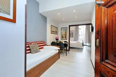 a bedroom with a bed and a dining room at 4BNB - Cavour Square Apartment in Rome