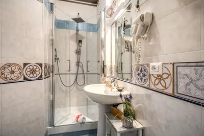 a bathroom with a sink and a shower at Santamaria Inn in Rome