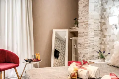 a bedroom with a bed and a fireplace at Santamaria Inn in Rome