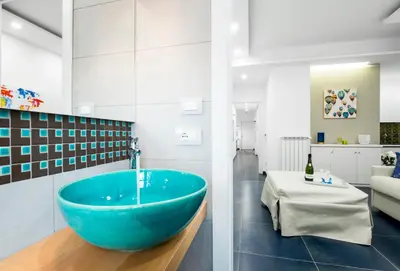 a bathroom with a large blue tub in the middle at Ma Belle Maison in Rome