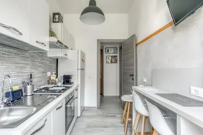 a kitchen with a sink and a counter top at Grand Sapienza Apartment by RHR in Rome