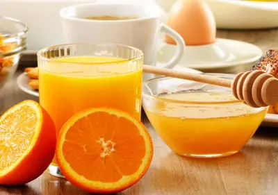 a glass of orange juice and orange slices on a table at My Bed Vatican Museum in Rome