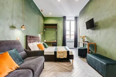 a living room with a couch and a bed at Ripetta Luxurious Suites in Rome