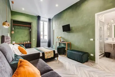 a living room with a couch and a bed at Ripetta Luxurious Suites in Rome