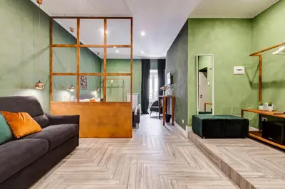 a living room with green walls and a couch at Ripetta Luxurious Suites in Rome