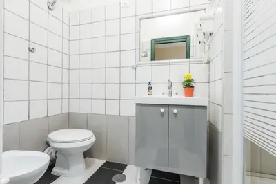 a bathroom with a toilet and a sink and a mirror at A Roma San Pietro Best Bed in Rome