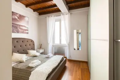 a bedroom with a bed and a large window at The Hide Trastevere in Rome