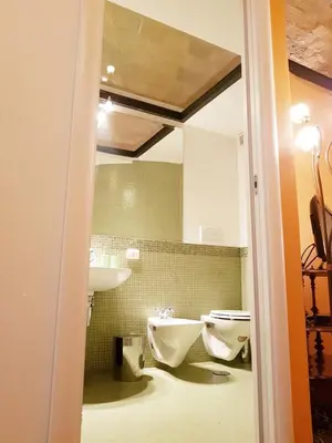 a bathroom with two sinks and two toilets at The Ancient Wall in Rome