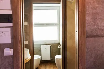 a bathroom with two toilets and a window at My Tiny Home in Rome