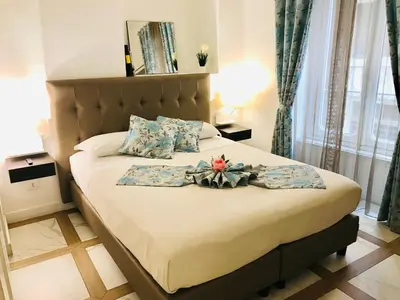 a bedroom with a bed with a flower arrangement on it at KAMBAL LUXURY SUITES in Rome
