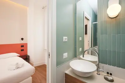 a bathroom with a sink and a mirror at DEM Hotel in Rome