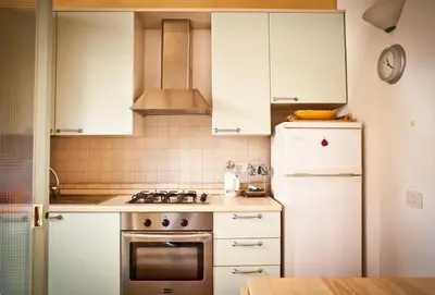 a kitchen with a stove and a refrigerator at Piazza Argentina/Pantheon in Rome