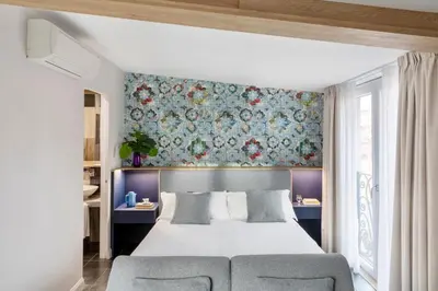 a bedroom with a bed and a floral wall at Patrizia Romana Palace in Rome