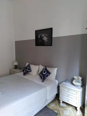 a bedroom with a bed with a tv on the wall at Trastevere Corner Eight in Rome