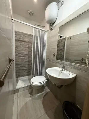 a bathroom with a toilet and a sink at Guest House Hola Roma in Rome