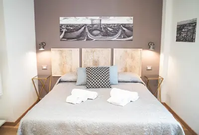 a bedroom with a large bed with two white pillows at Verrazzano 37 Guest House in Rome