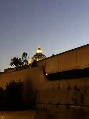 a building with a dome in the background at night at Art Atelier San Pietro in Rome
