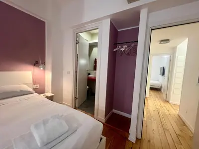 a bedroom with a white bed and a mirror at Atelier San Pietro in Rome