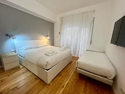 a bedroom with a white bed and a window at Atelier San Pietro in Rome