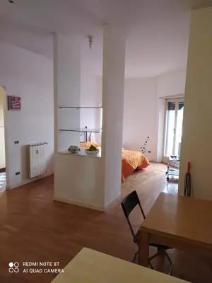 a living room with a bed and a table at Marco's House in Rome