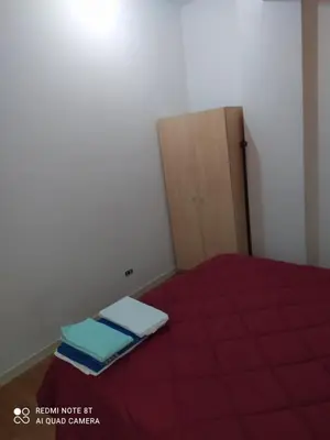 a small bedroom with a bed and a wooden door at Marco's House in Rome