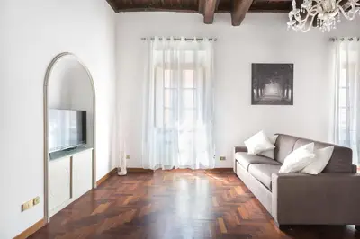 a living room with a couch and a tv at A World Aparts - 143 Sistina in Rome