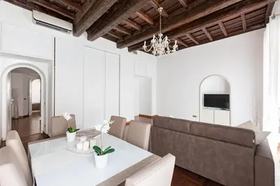 a dining room with a white table and chairs at A World Aparts - 143 Sistina in Rome