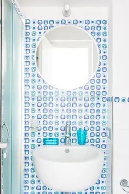 a bathroom with a white sink and a mirror at A World Aparts - 143 Sistina in Rome