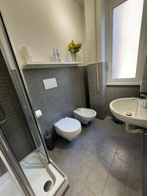 a bathroom with a toilet and a sink at Tiburtina Suites, Roma in Rome
