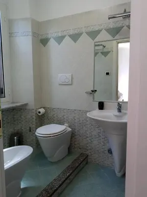 a bathroom with a toilet and a sink at La Casa Dell'Arte in Rome