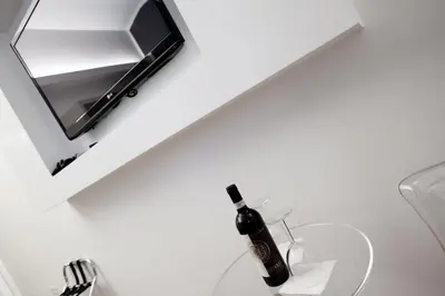 a bottle of wine on a counter next to a mirror at Town House Fontana Di Trevi in Rome