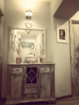 a wooden dresser with a mirror in a room at Domus Ferruccio in Rome
