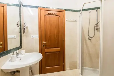 a bathroom with a sink and a shower at Casa Sangallo in Rome