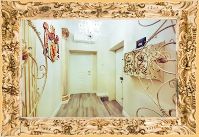 a mirror in a gold frame in a hallway at Impero Vaticano Suites Guest House in Rome