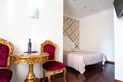 a bedroom with a bed and a table and chairs at Royal House in Rome