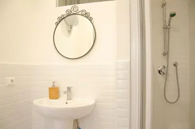 a bathroom with a sink and a mirror on the wall at By Grace in Rome