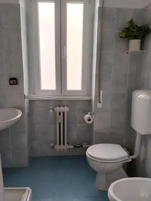 a bathroom with a toilet and a sink at By Grace in Rome