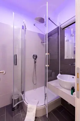 a bathroom with a shower and a sink at Dolce Luxury Rooms in Rome