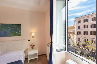 a bedroom with a bed and a large window at Rome To Stay in Rome