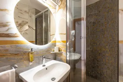 a bathroom with a sink and a mirror at Rome To Stay in Rome