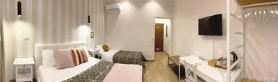 a hotel room with two beds and a television at Monti49 GuestHouse in Rome