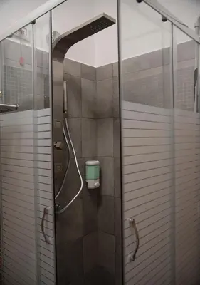 a shower with a glass door in a bathroom at Monti49 GuestHouse in Rome