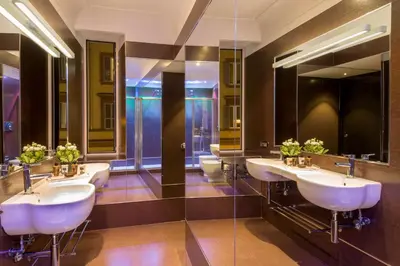 a bathroom with three sinks and two toilets at St. Peter Guest House in Rome