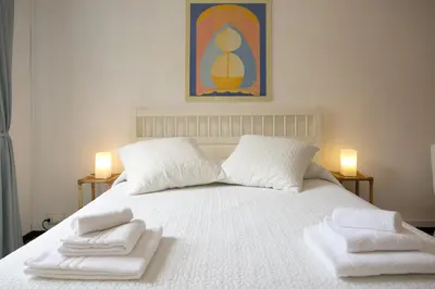 a bedroom with a white bed with towels on it at Morin 27 in Rome