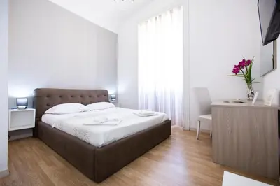 a bedroom with a large bed and a window at El Dorado Vatican in Rome