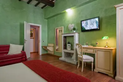 a green bedroom with a bed and a fireplace at Navona Tower Relais in Rome