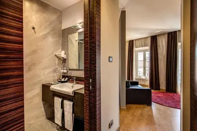 a bathroom with a sink and a mirror at Trevi Collection Hotel - Gruppo Trevi Hotels in Rome
