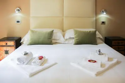 a bedroom with a bed with two towels on it at Navona First Rooms in Rome